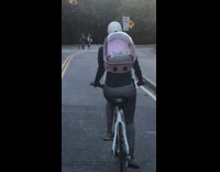 Woman pink backpack bird bike