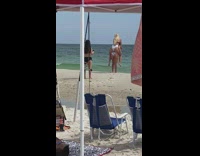 Girl photographs two friends piggy back ride 