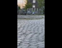 Green jacket white pants guy dances graffiti 