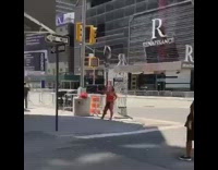 Red shirt girl brushes teeth on sidewalk 