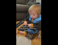 Little boy in blue vest learning colors