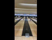 Two men bumps bowling ball and both gets a strike