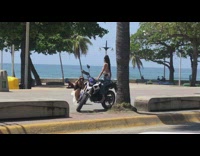 Woman white top sits on motorcycle pictorial