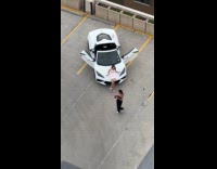 Woman pink dress car photoshoot parking lot