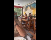 Couple films their food inside the restaurant