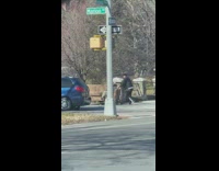 Man Pushes Couch on Cart while Friend is Seated