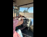 Man teaching sister how to drive tractor 
