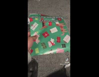 Guy puts wrapping paper over gap of present 