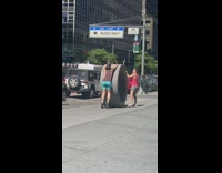 Two men roll round couch on street part 1