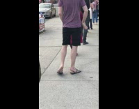 Guy waits in line stands on tiptoes 