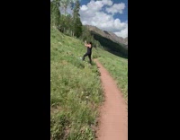 Girl jeans lay on grass mountain hike