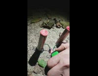 Guy lights two red fireworks green lighter 