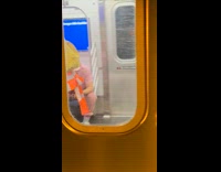 Collab Subway Creatures - Woman traffic cone on head walk inside train