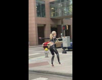 Woman in black outfit ballet jump on the sidewalk