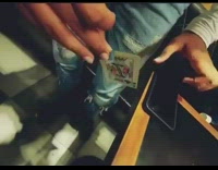 Guy holds playing card ripped torn edge