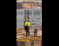 Construction worker dancing on top of construction site