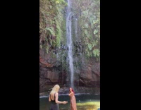 Woman red hair dress pose on waterfalls