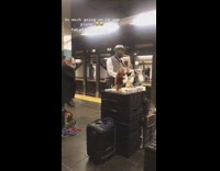 Busy subway station, man spinning around, man playing Despacito on saxophone