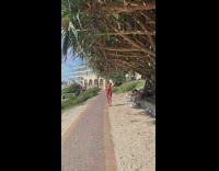 Girl barefoot on sand pink skirt 