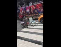 Old man ride bike drag chair street