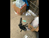 Girl sees broken black toy on sidewalk 