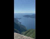 Woman peace sign on mountain summit rock