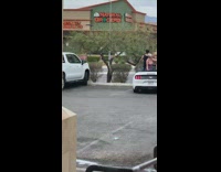 Shirtless girls dance on white convertible car