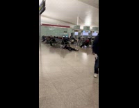 Man asleep on the airport lobby floor