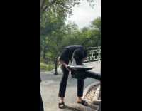 Man gives water to cat from mouth