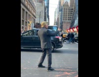 Man in Trump costume directing traffic 