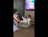 Baby boy falls off cushion white pajamas