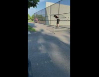 Guy squats with metal barrier black shirt 