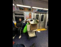 Man holds sword toilet brush inside train