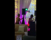 Woman selfie dance video beside the DJ booth
