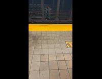 Collab WINY - Man cross subway train tracks as he carries bike