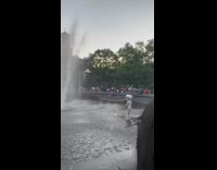 Human statue person stands water fountain park 