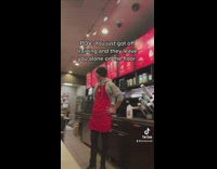 Guy red apron starbucks by himself 