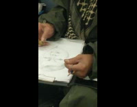 Black hat guy draws sketches portrait subway