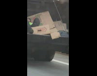 Guy sits inside dumpster truck