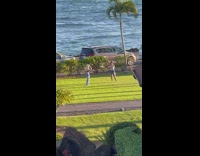 Woman in black crop top poses at the lawn