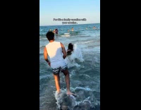 Guy being rough push cousins at beach