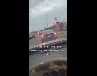 Cars driving around train tracks