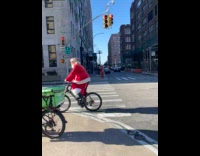 Old man Santa costume ride bike street