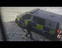 Two officer push police van stuck snow