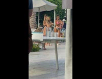 Three girls dance by pool white umbrella 