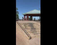 Nine year old boy riding skateboard jumps over steps  
