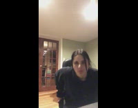 Girl leans on black chair falls backwards 