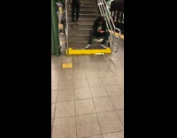 Man eating crab legs on subway stairs