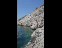 Bikini girl attempts to dive off rock 