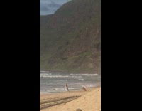 Girl loose pants walk beach waves mountain
